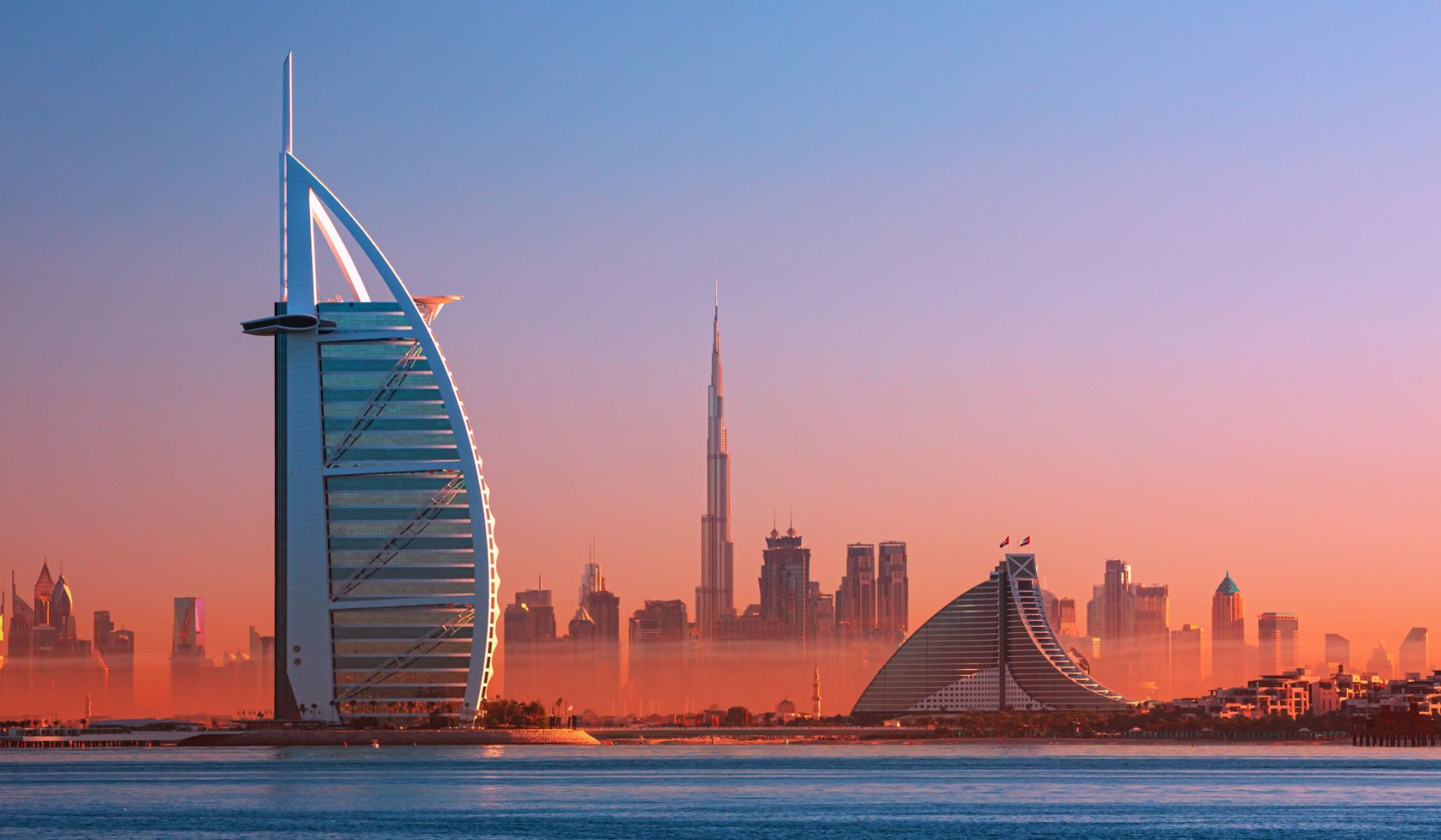 Dubai city - amazing city center skyline and famous Jumeirah beach at sunset, United Arab Emirates